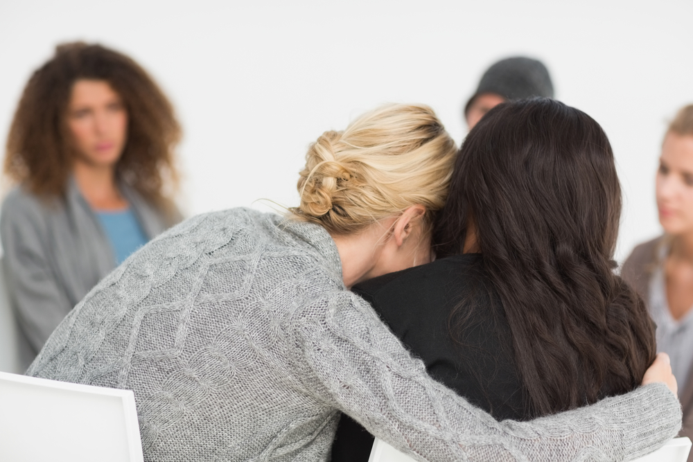 Women embracing support group member